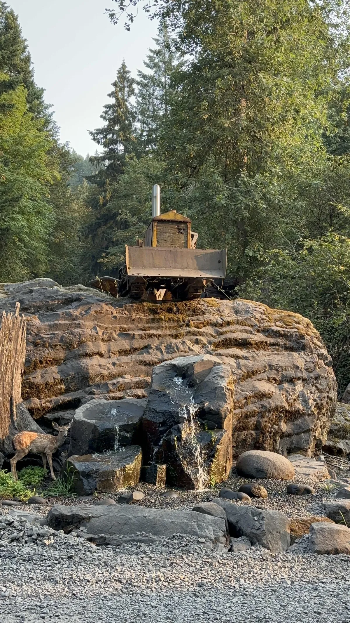 Bulldozer atop a massive basalt rock formation at the Liberty Rock quarry in Sweet Home, Oregon